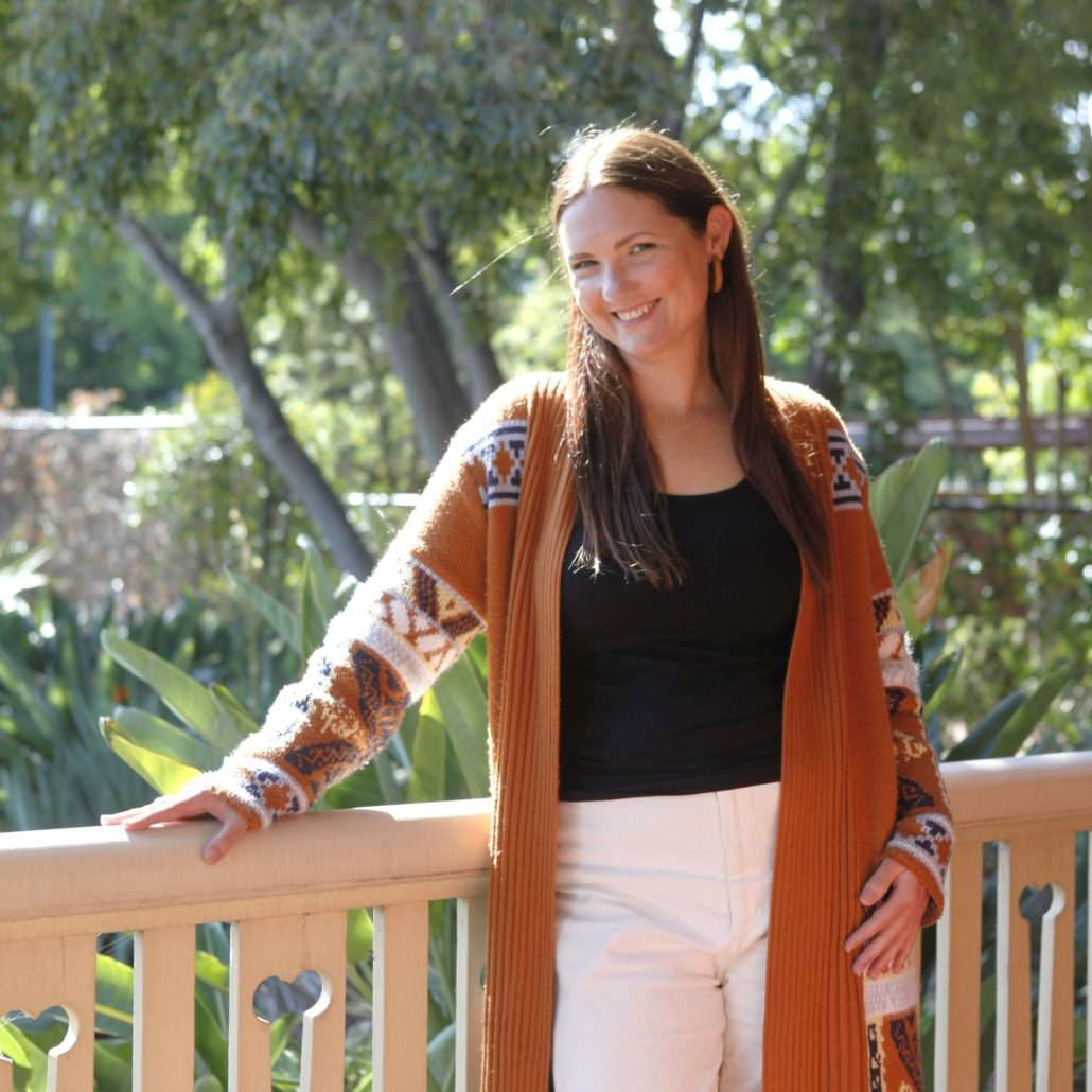 Toni Stevens Hypnosis and therapeutic coach Toni Stevens hypnotherapist and therapeutic coach standing by a railing